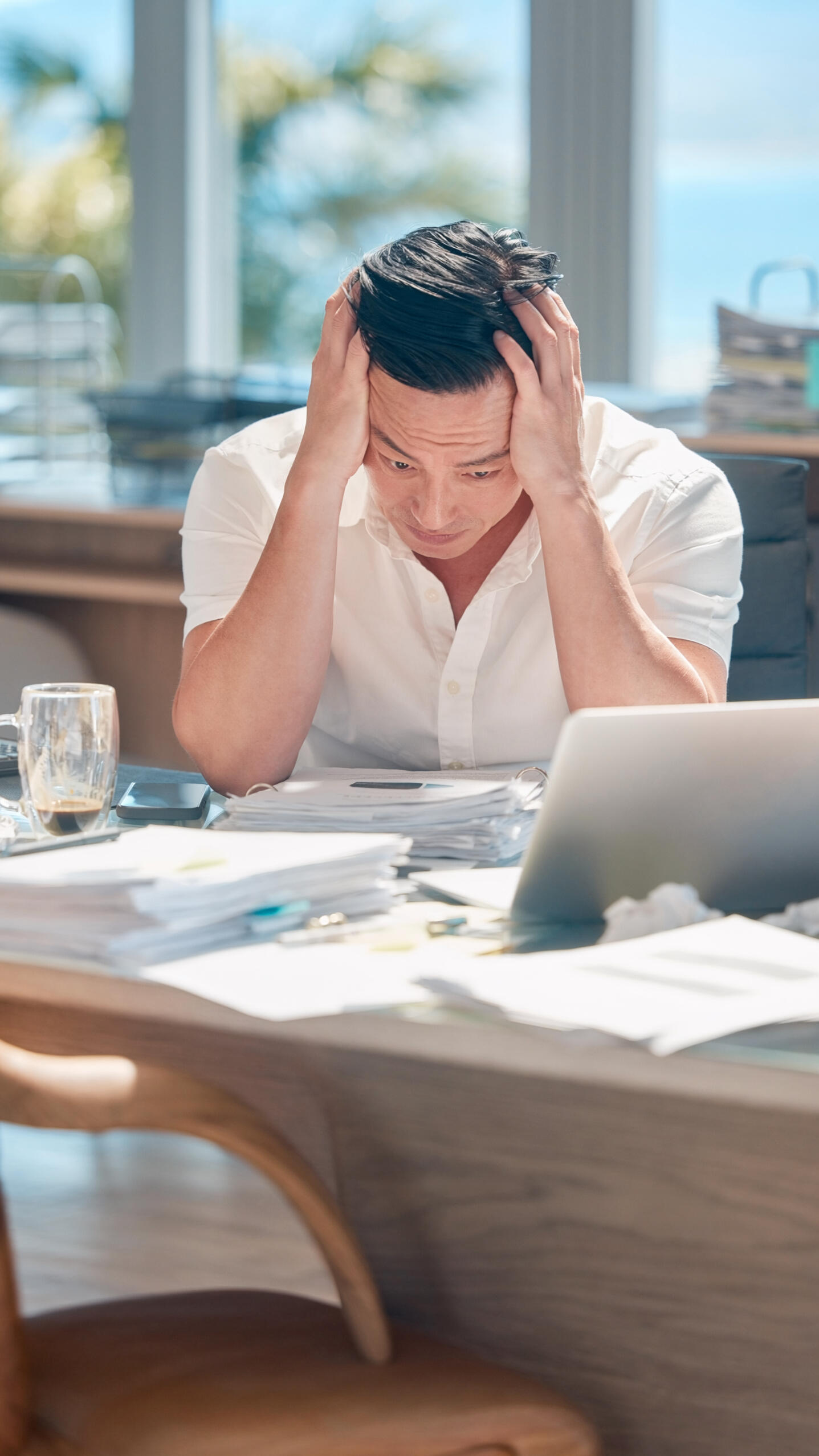 stressed executive reviewing paperwork